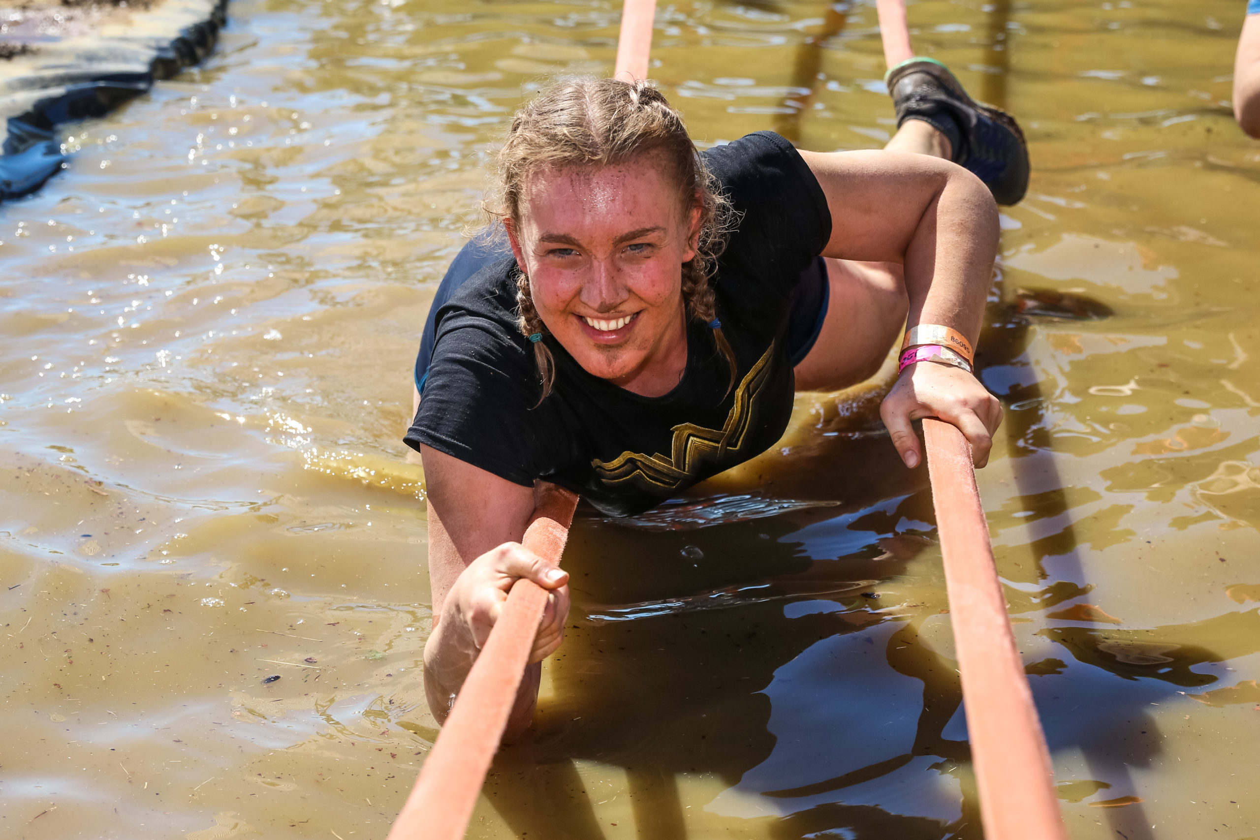 Girl on straps over water