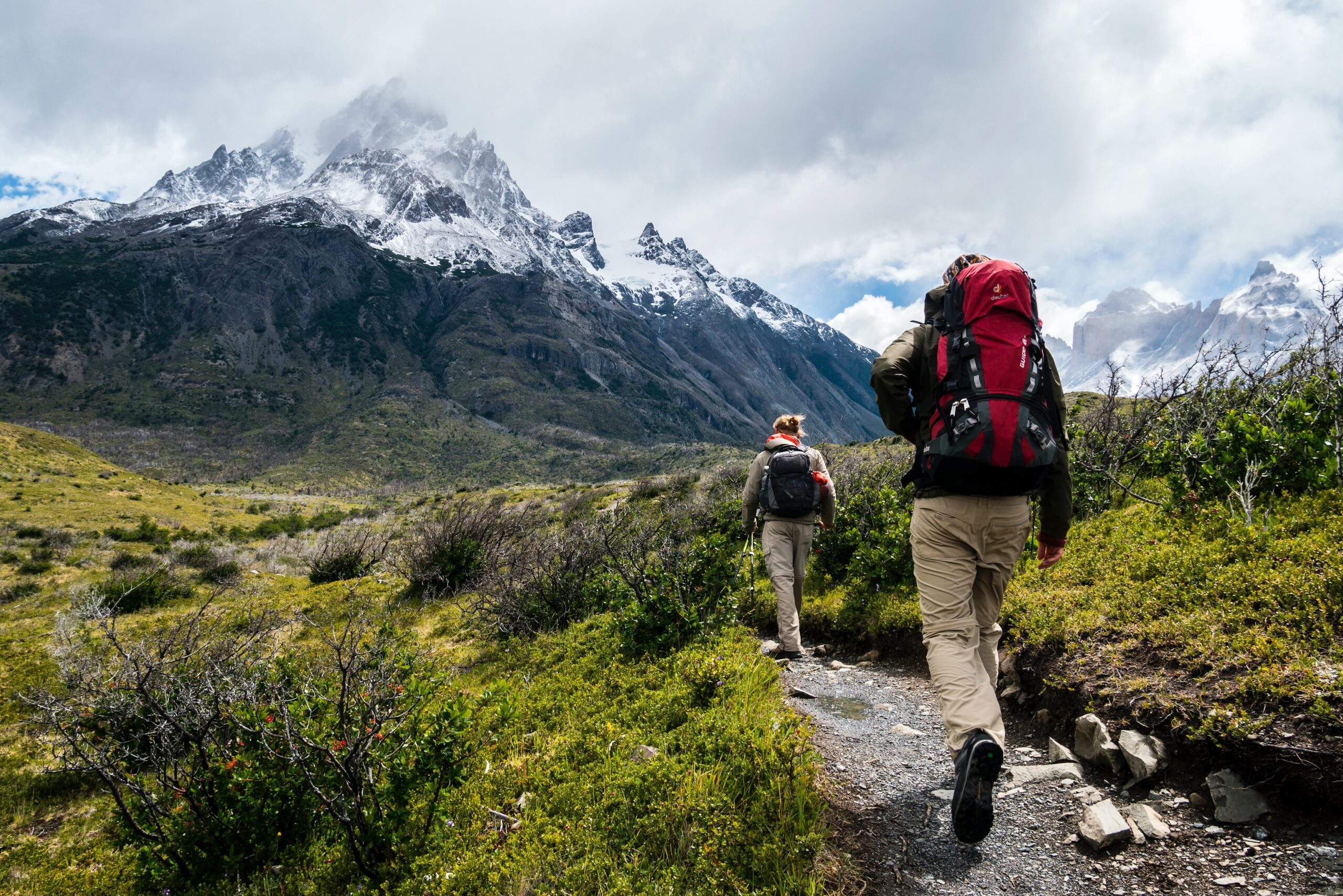 Two people hiking towards mountain
