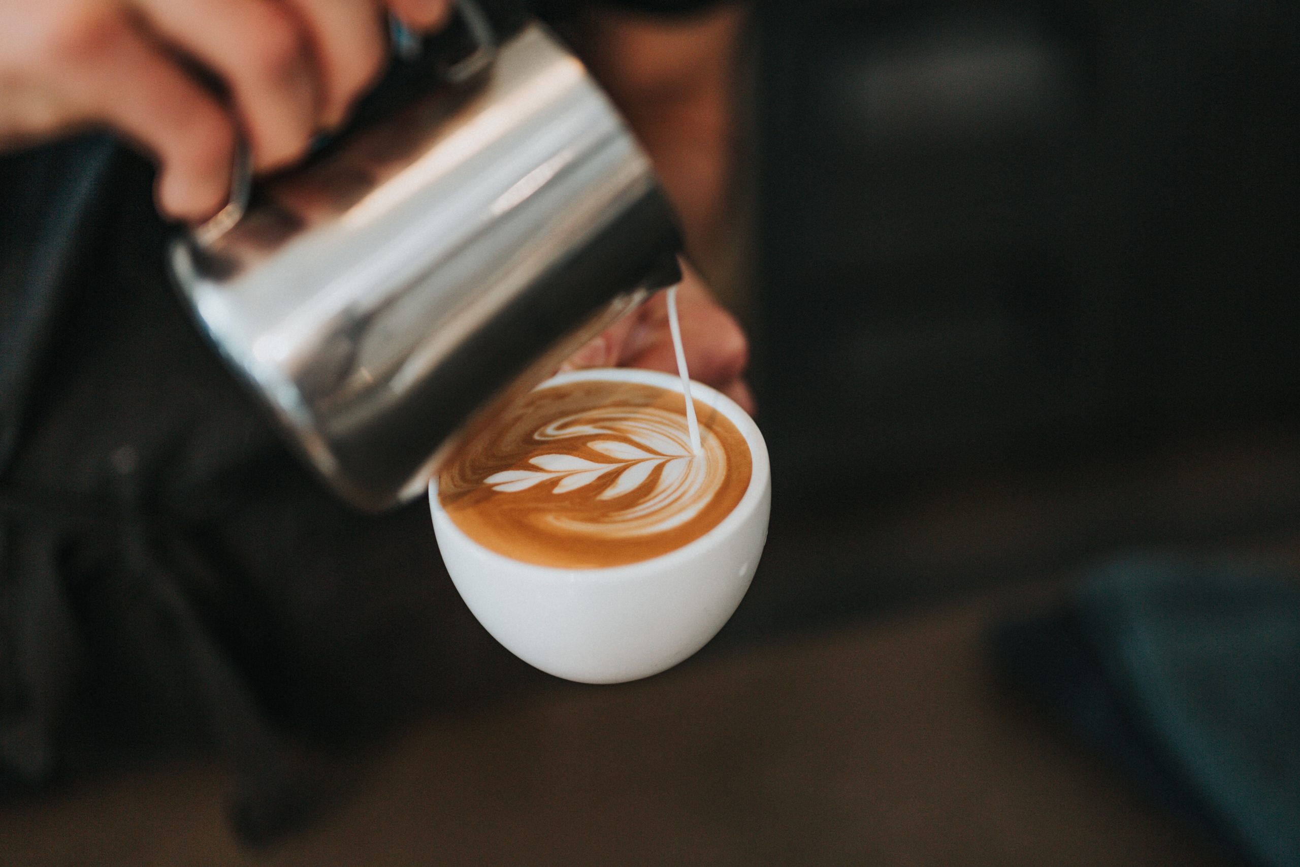 Milk being poured into a coffee