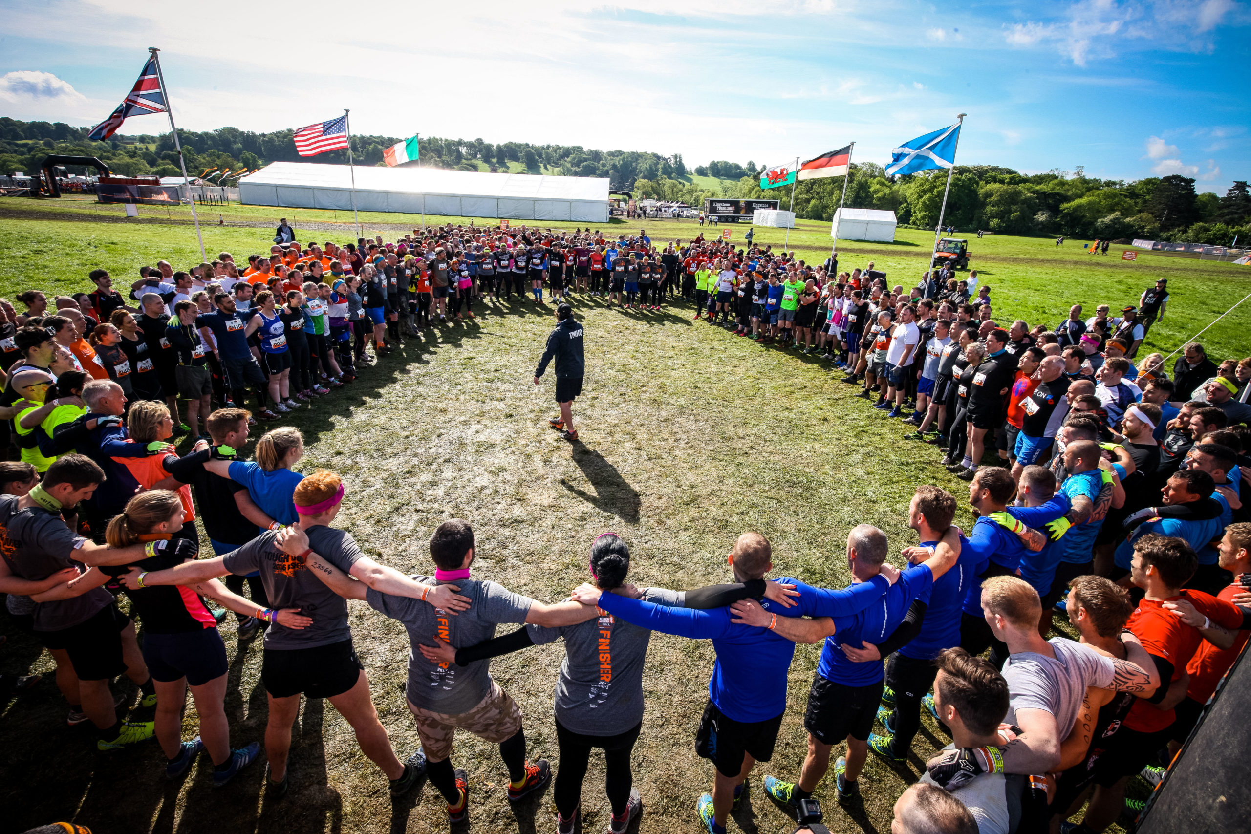 A large group of people stand in a circle.