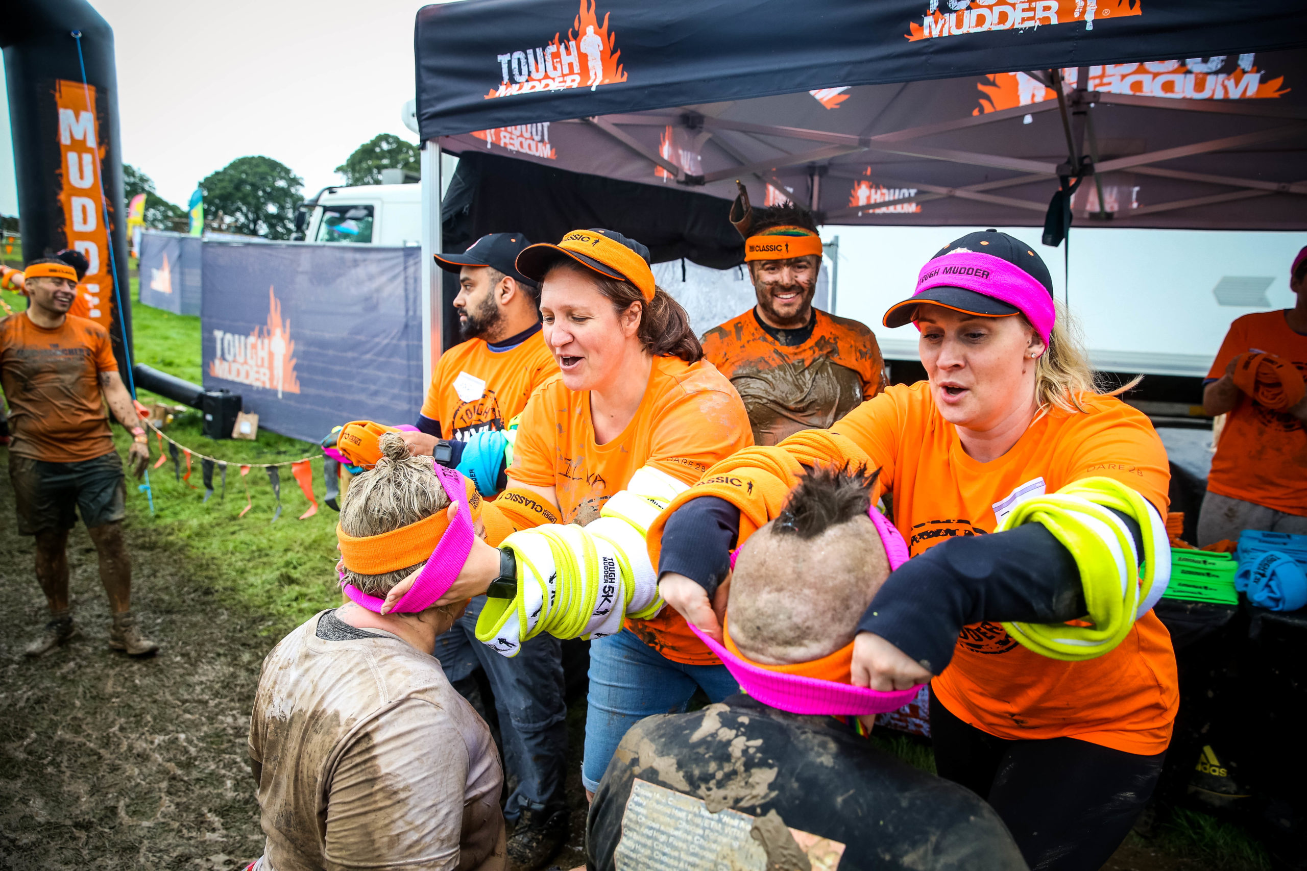 Volunteers placing headbands on people