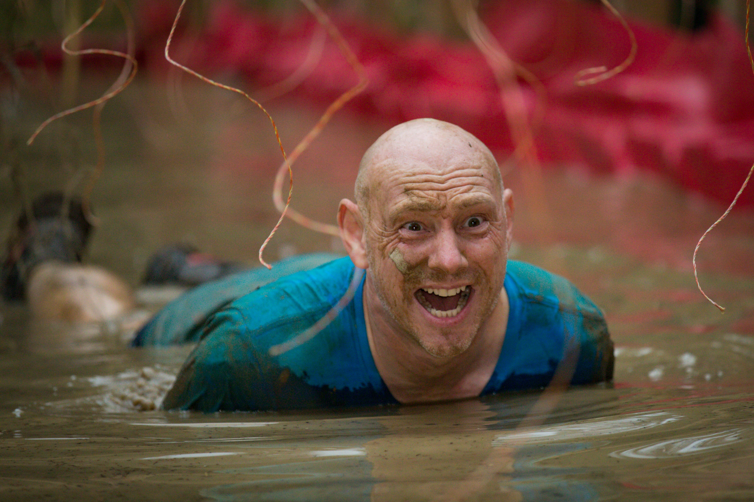 Man laying in muddy water