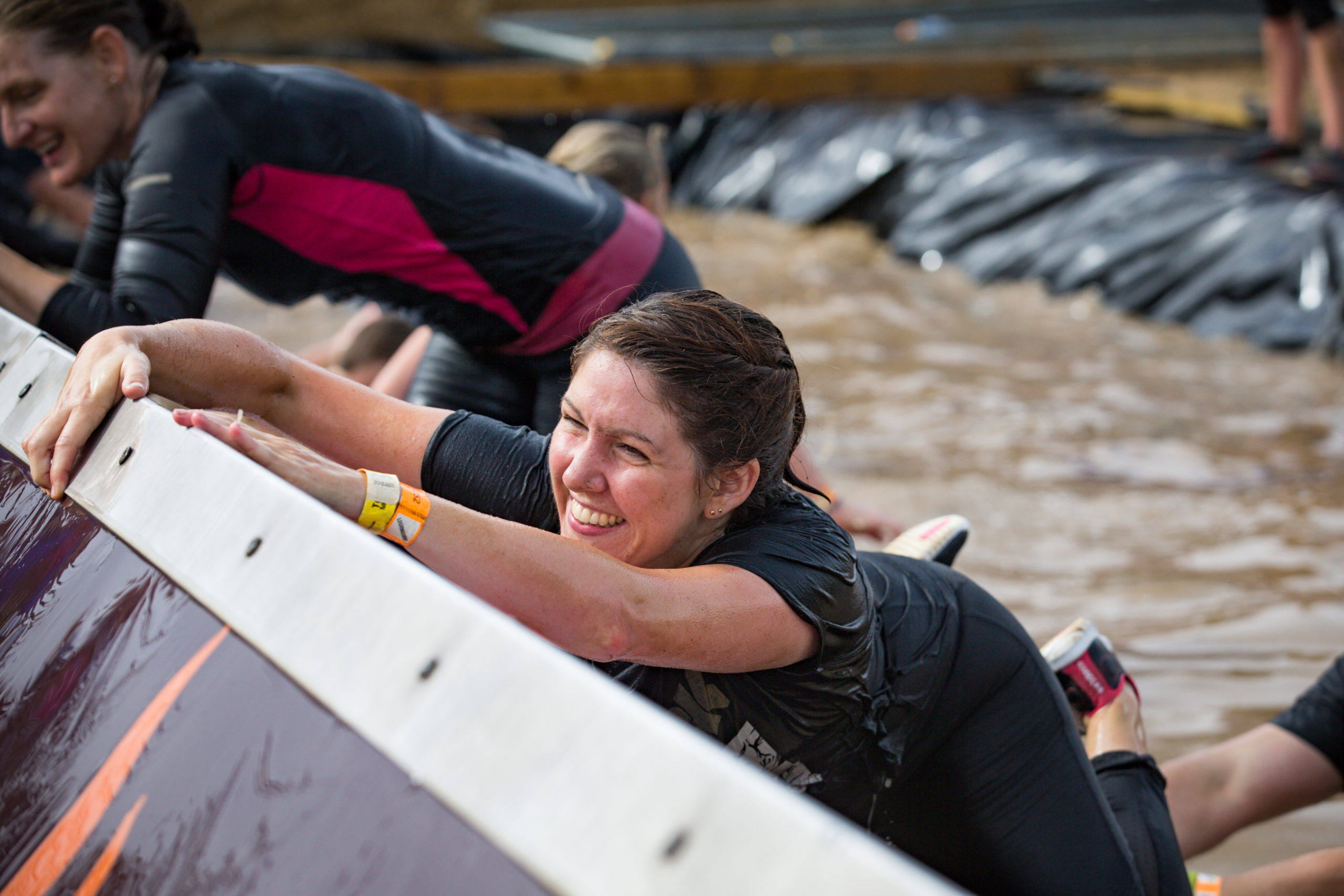 A woman hangs onto block in water