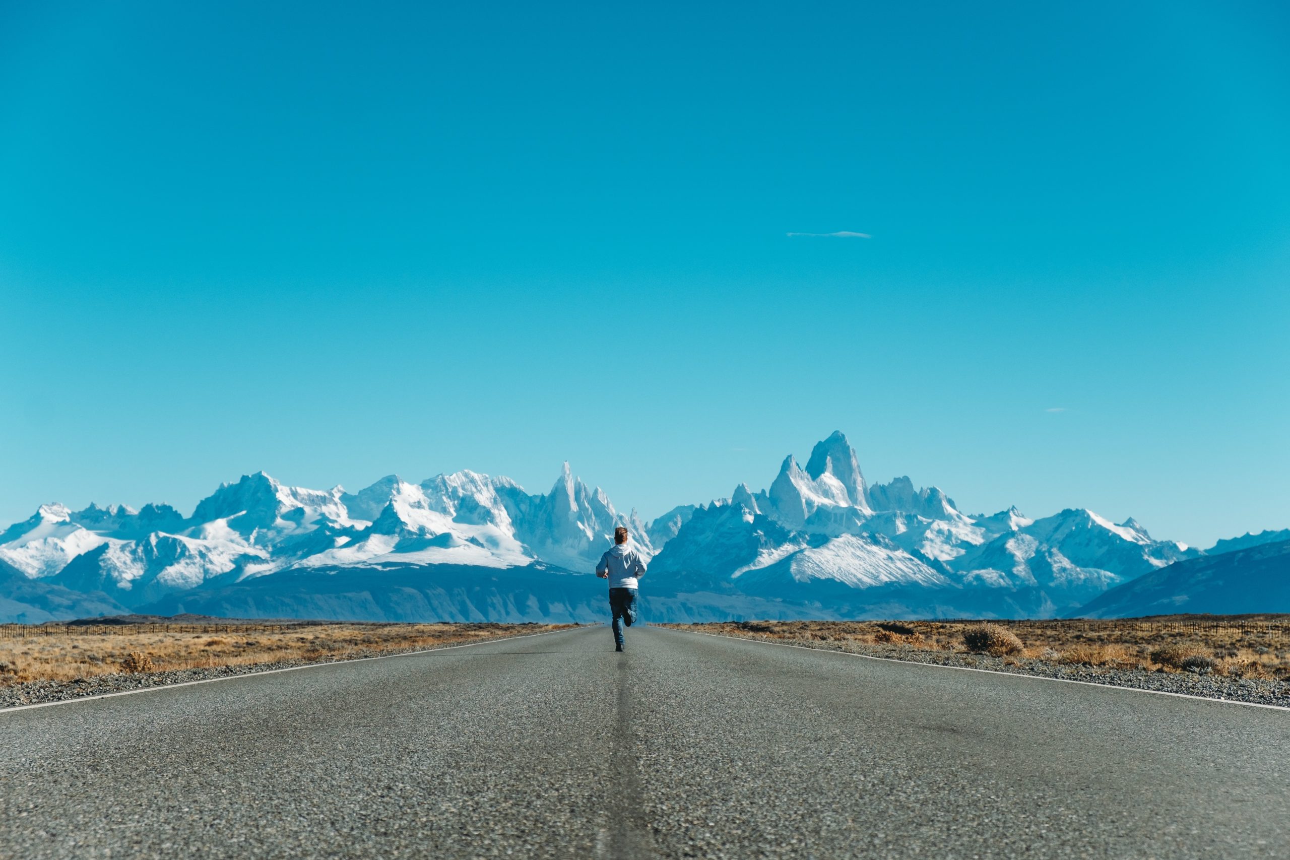 Person running towards mountain range