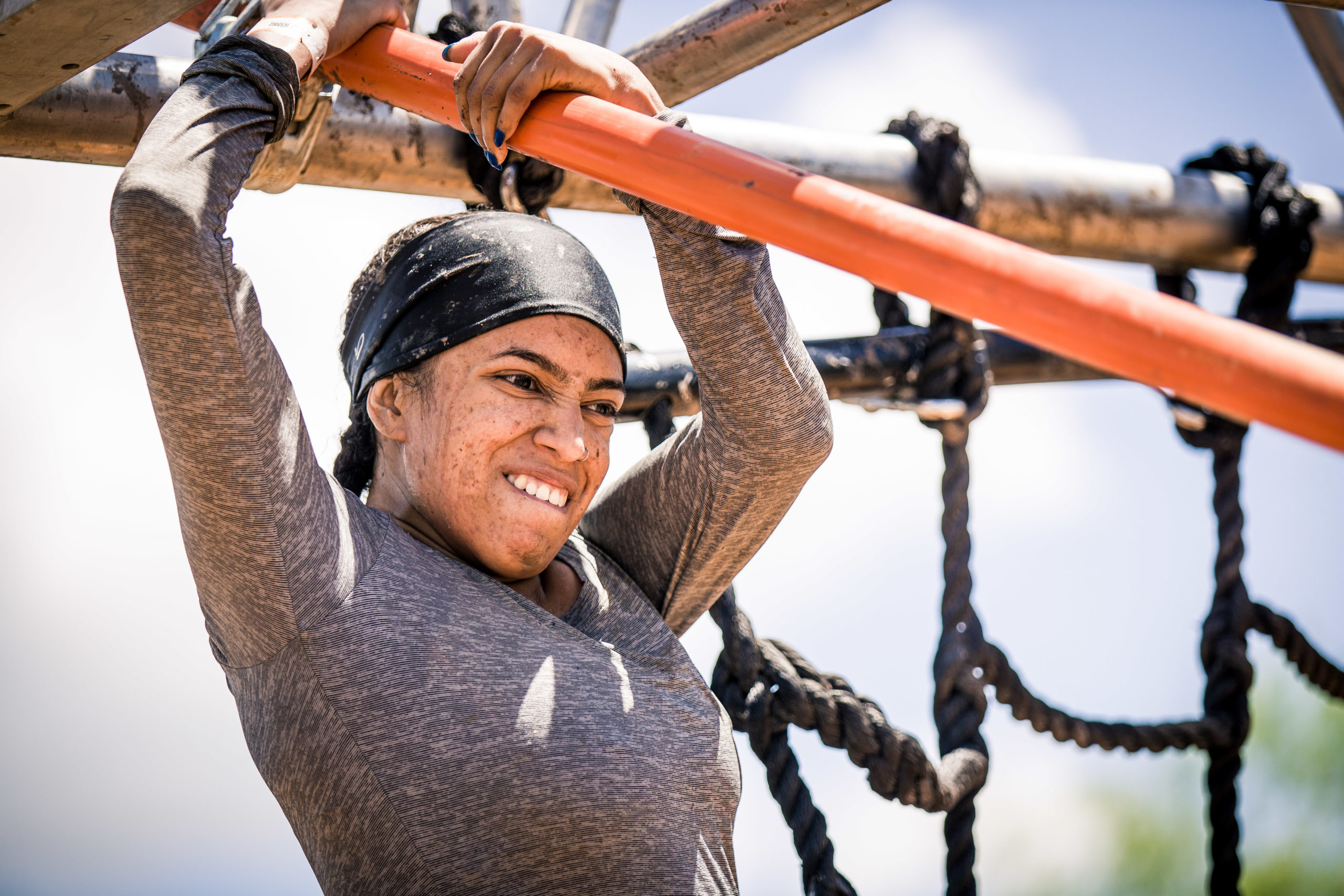 Participant gritting her teeth while holding tightly on a metal bar