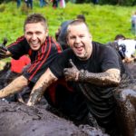 two men in mud Scotland event